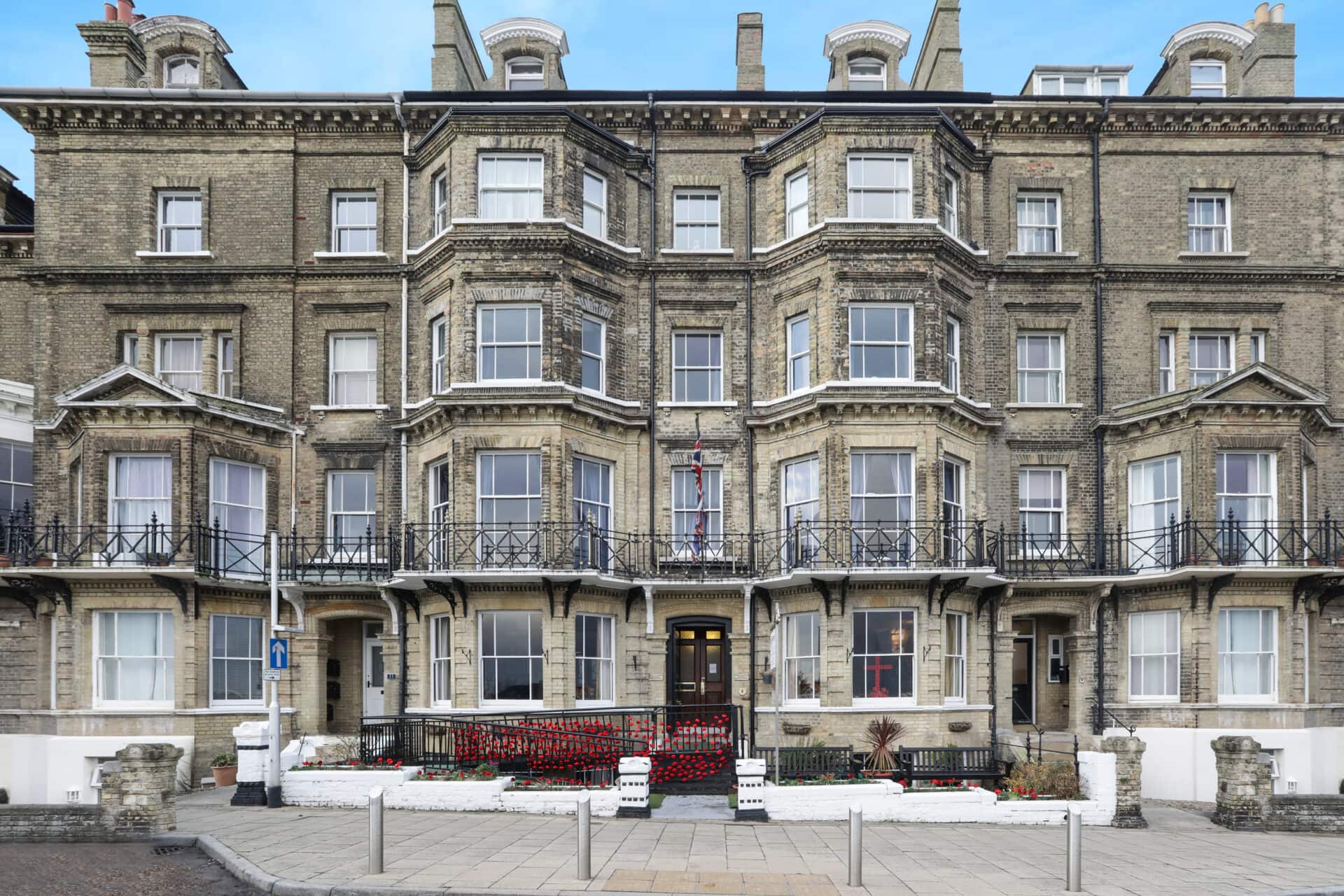 Victorian-style building with balconies and ornate details, currently used as a hotel.